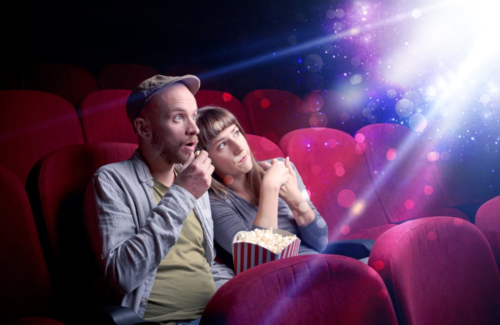 Blog 2 Romantic couple cuddling and watching the miraculous part of the film